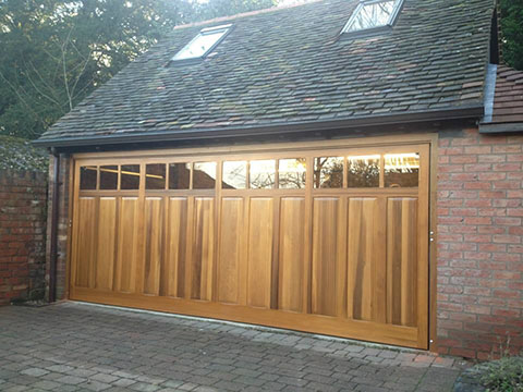 Woodrite cedar wood double up and over garage door, automated with optional glazing installed by us..